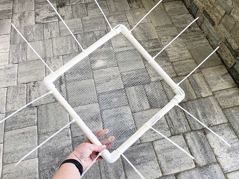 Using zip ties to attach wire for a DIY Shark Tooth Sand Sifter